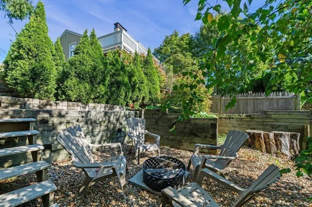 a view of a chairs and table in backyard