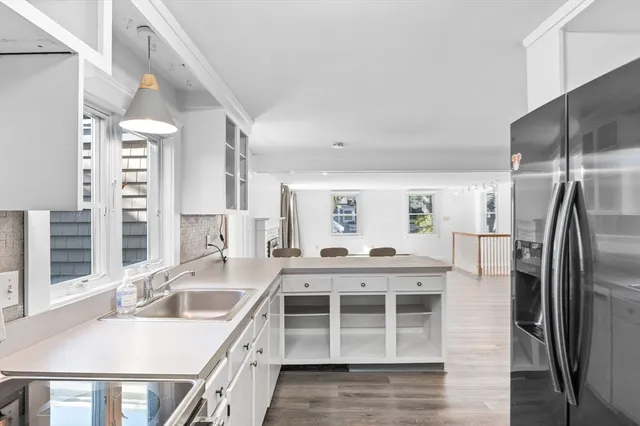 a kitchen with stainless steel appliances granite countertop a sink and a refrigerator