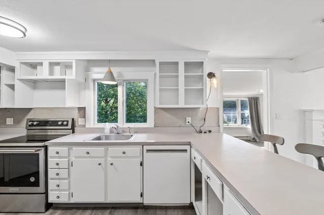 a kitchen with a sink stove and cabinets