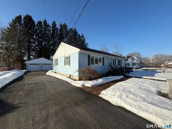 a view of house with outdoor space and sitting area