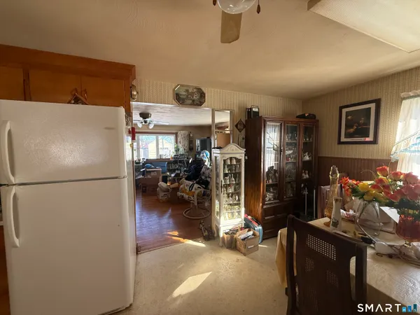 a white refrigerator freezer sitting in a kitchen