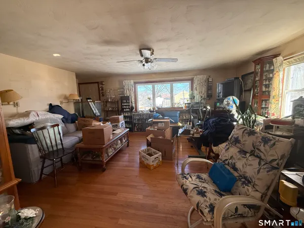 a living room with furniture window and wooden floor