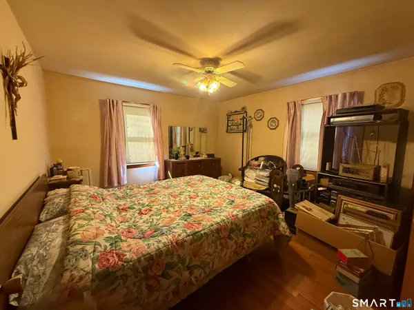 a bedroom with bed and window