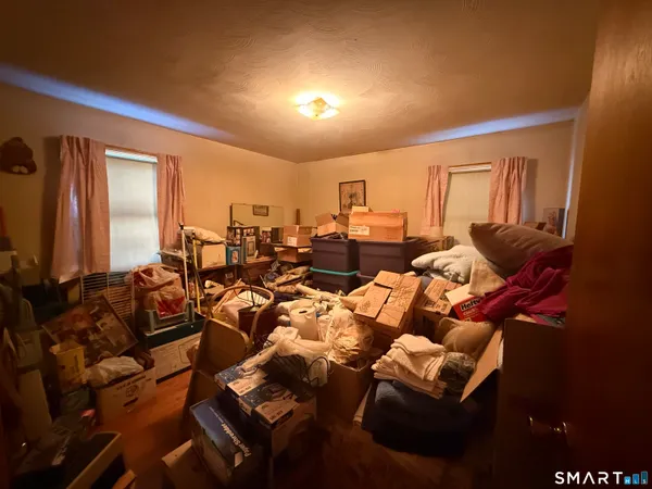 a living room with furniture kitchen view and a flat screen tv