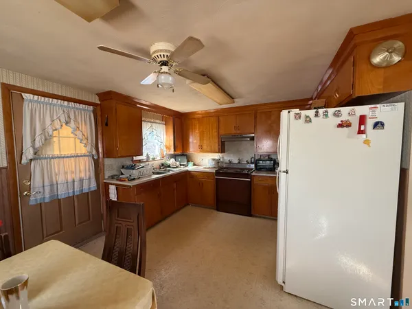 a kitchen with a refrigerator a sink and cabinets
