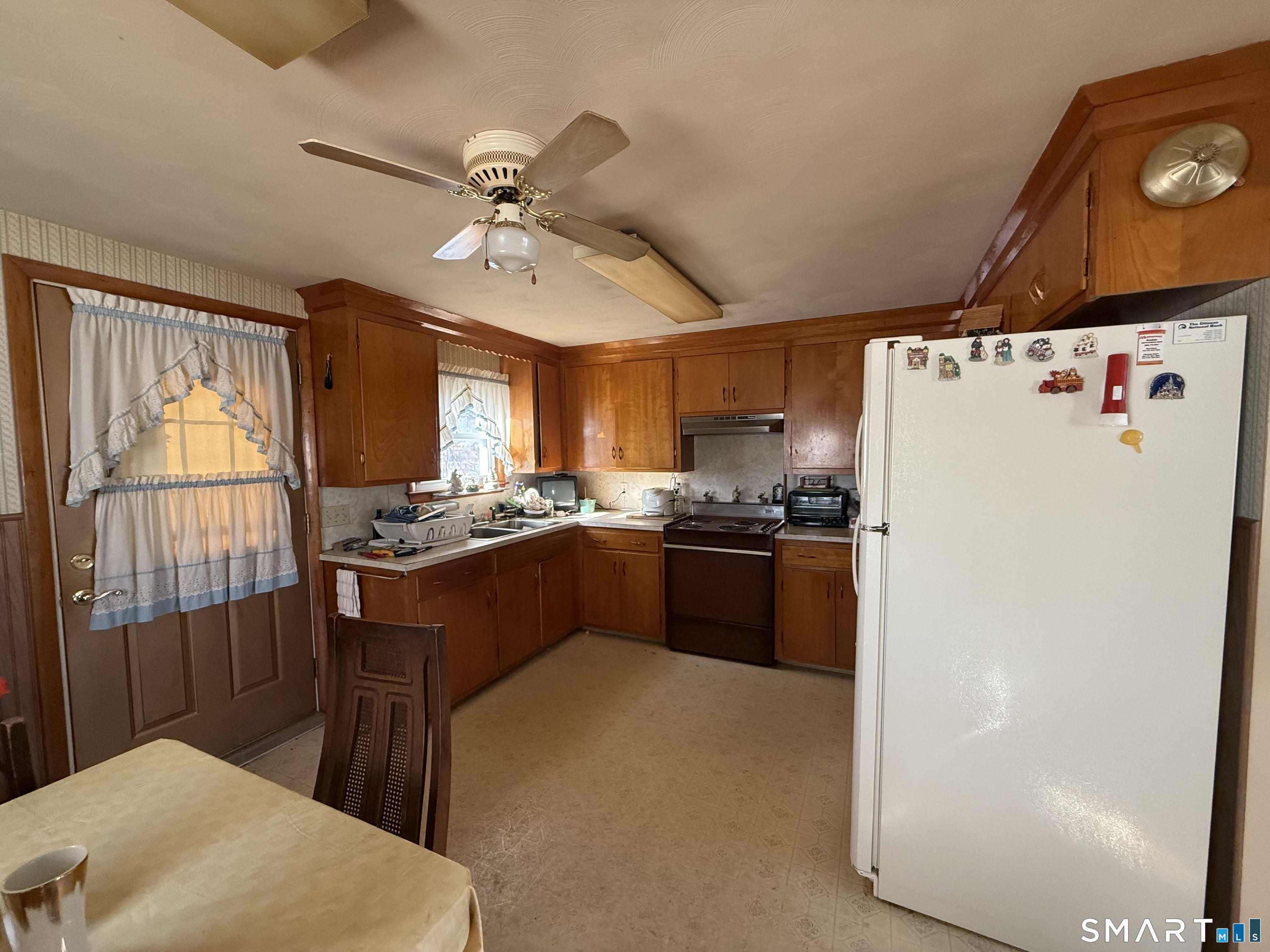 29 Rosedale Street Killingly, CT 06239 - Photo 8 of 23 a kitchen with a refrigerator a sink and cabinets