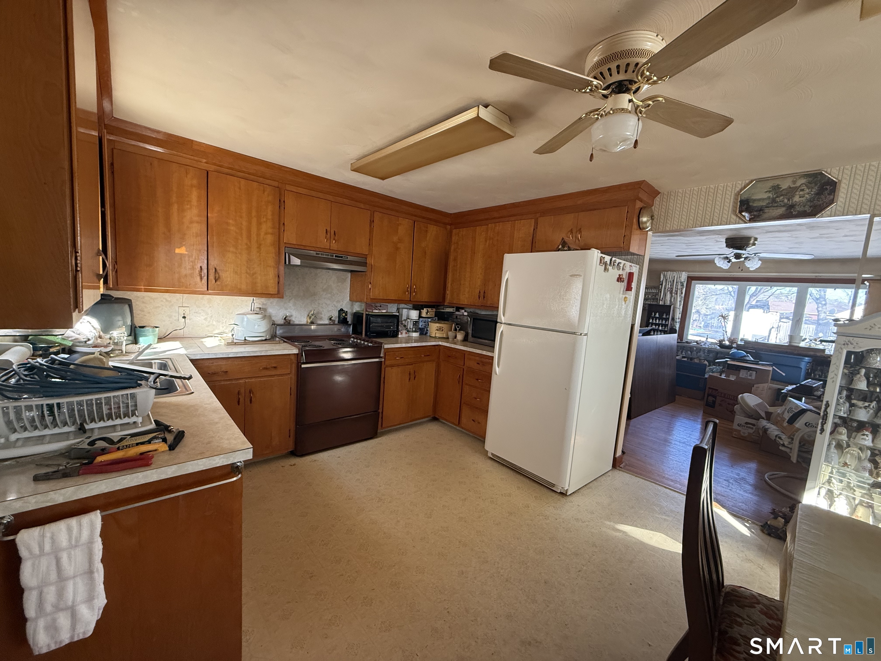 29 Rosedale Street Killingly, CT 06239 - Photo 9 of 23 a kitchen with a refrigerator a stove top oven a sink and cabinets