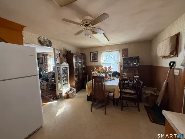 a view of a livingroom with furniture and a ceiling fan