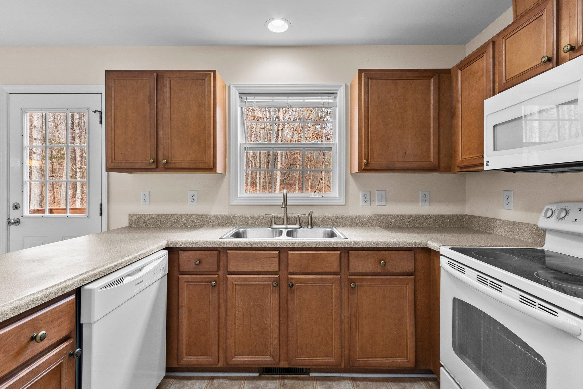 6041 Burgundy Road Durham, NC 27712 - Photo 13 of 45 a kitchen with stainless steel appliances granite countertop wooden cabinets a sink and a stove