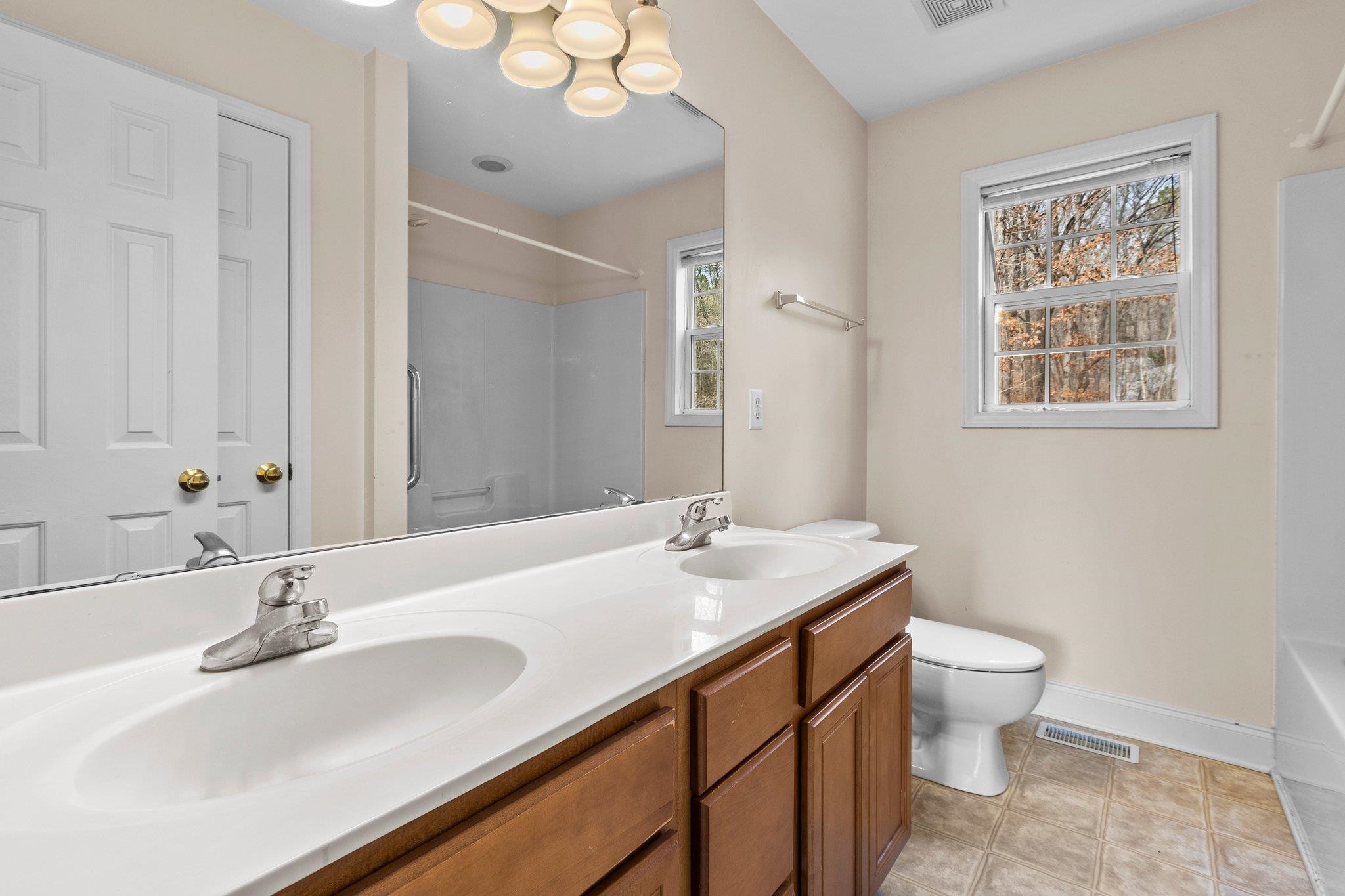 6041 Burgundy Road Durham, NC 27712 - Photo 18 of 45 a bathroom with a sink and a mirror