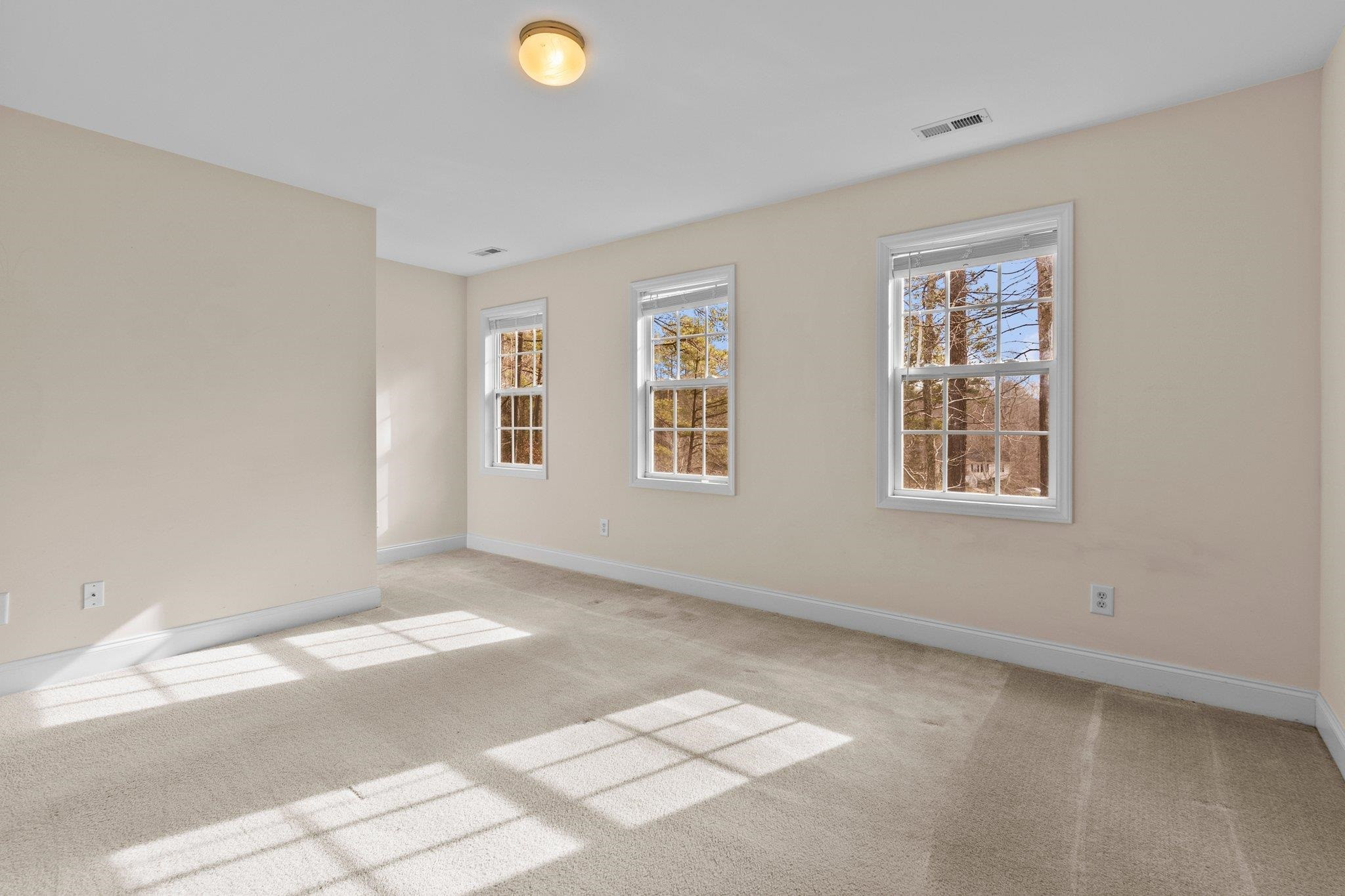 6041 Burgundy Road Durham, NC 27712 - Photo 24 of 45 a view of an empty room with windows