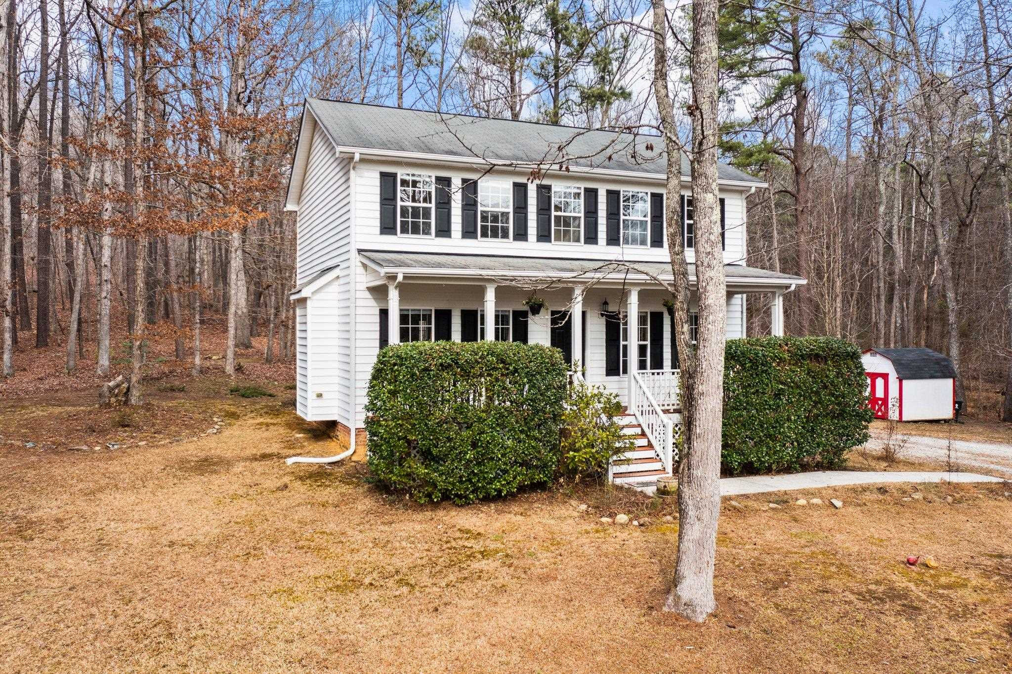6041 Burgundy Road Durham, NC 27712 - Photo 4 of 45 a front view of a house with a yard