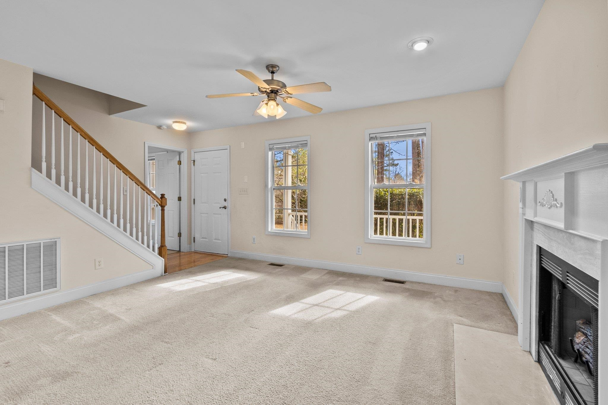 6041 Burgundy Road Durham, NC 27712 - Photo 9 of 45 a view of empty room with fireplace and fan