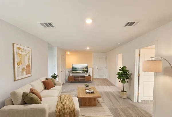 a living room with furniture and a potted plant