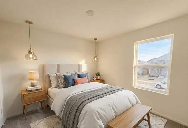 a bedroom with bed and a window