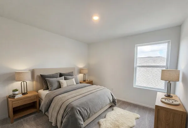 a bedroom with a bed and a lamp