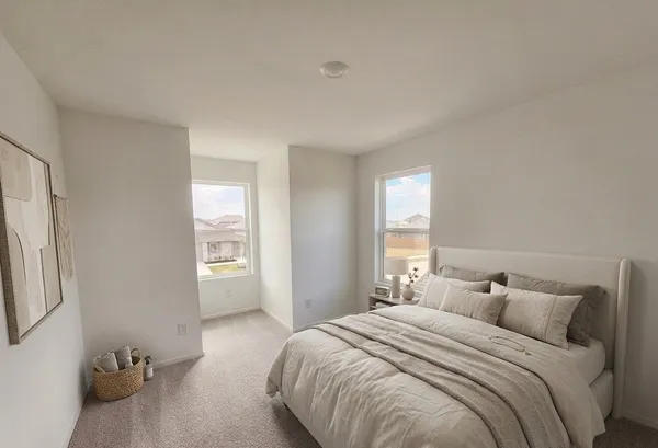 a bedroom with a bed and window