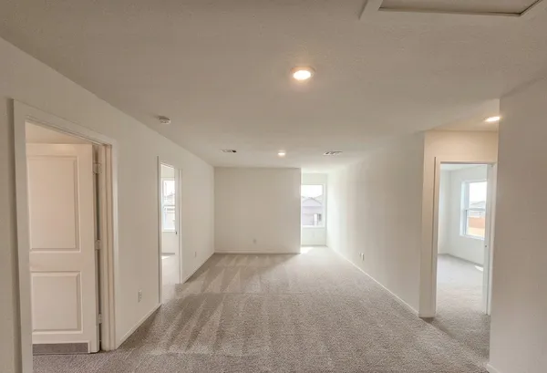 a view of hallway with windows and stairs