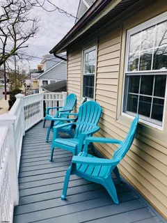 a view of sitting area with chairs on wooden deck