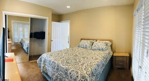 a bedroom with a bed and flat screen tv