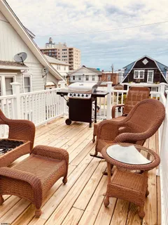 a balcony with table and chairs