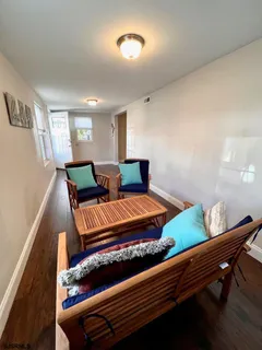 a bedroom with furniture and wooden floor