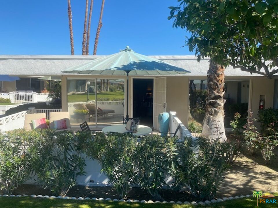 2033 Ramon Road, Unit 4B Palm Springs, CA 92264 - Photo 1 of 44 a front view of a house with a yard