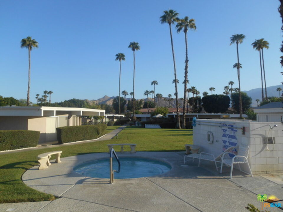 2033 Ramon Road, Unit 4B Palm Springs, CA 92264 - Photo 11 of 44 a view of a swimming pool with a table and chairs