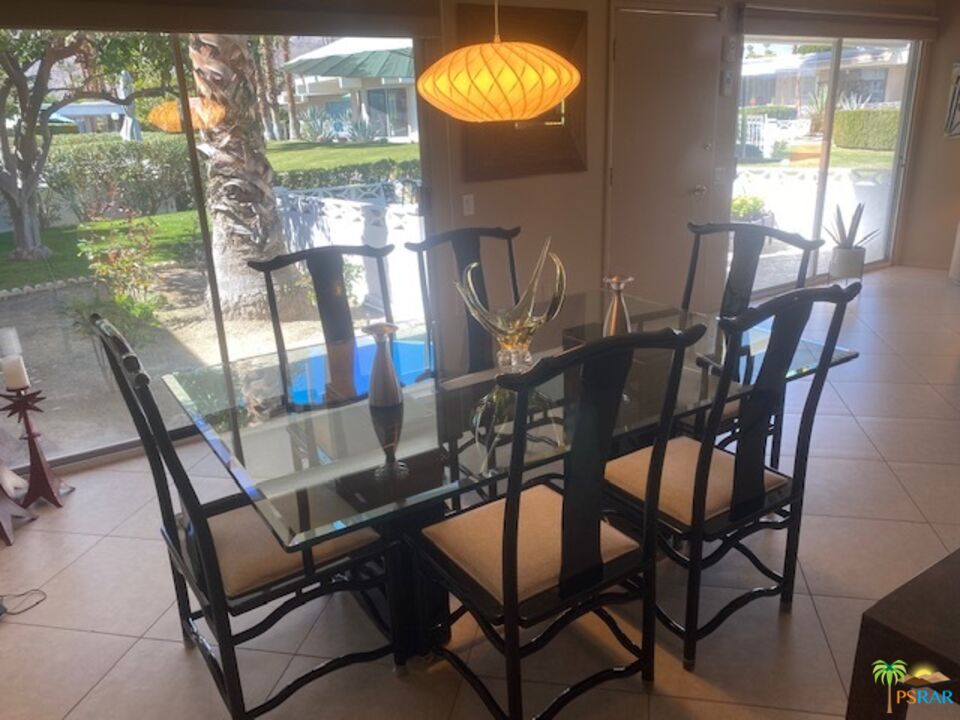 2033 Ramon Road, Unit 4B Palm Springs, CA 92264 - Photo 15 of 44 a view of a dining room with furniture and wooden floor