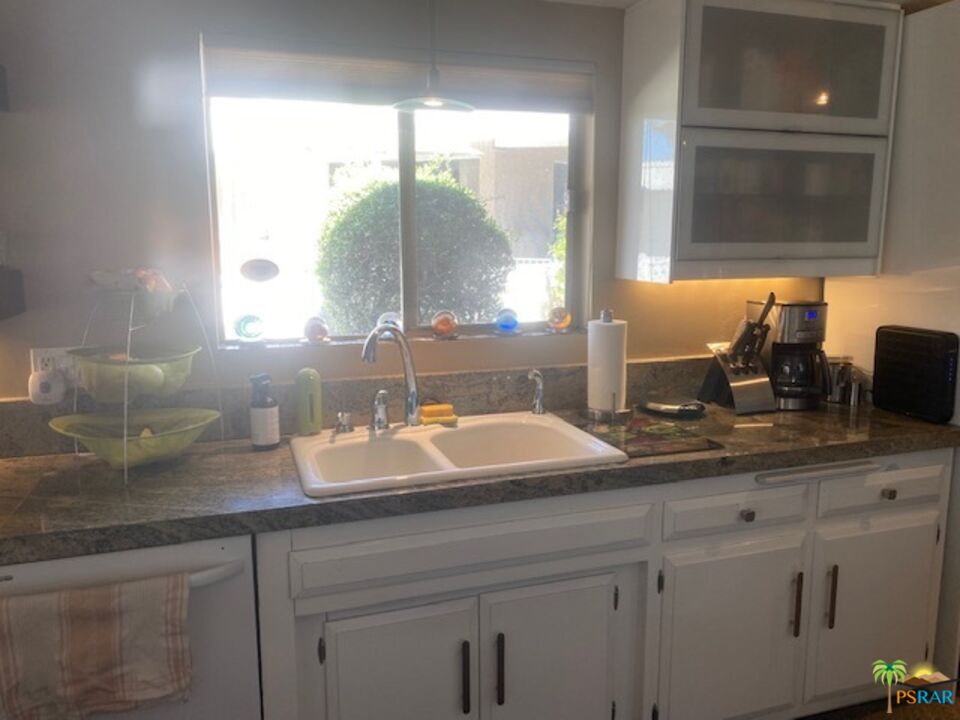 2033 Ramon Road, Unit 4B Palm Springs, CA 92264 - Photo 23 of 44 a bathroom with a sink and a mirror