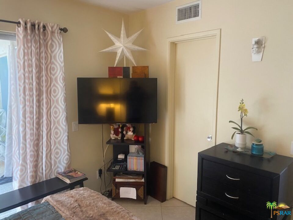 2033 Ramon Road, Unit 4B Palm Springs, CA 92264 - Photo 27 of 44 a living room with furniture and a flat screen tv