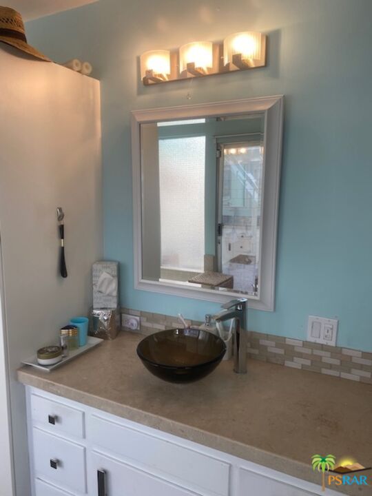 2033 Ramon Road, Unit 4B Palm Springs, CA 92264 - Photo 32 of 44 a bathroom with a sink and a mirror
