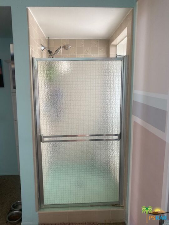 2033 Ramon Road, Unit 4B Palm Springs, CA 92264 - Photo 34 of 44 a bathroom with a glass shower door