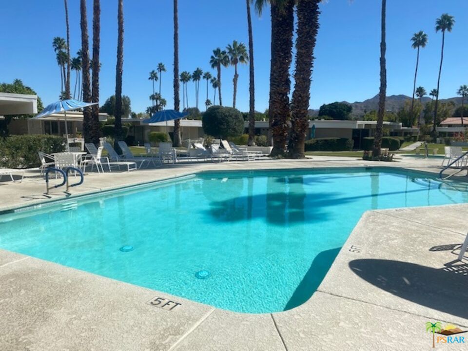 2033 Ramon Road, Unit 4B Palm Springs, CA 92264 - Photo 38 of 44 a view of a swimming pool with chairs