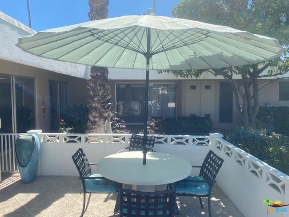2033 Ramon Road, Unit 4B Palm Springs, CA 92264 - Photo 41 of 44 a patio with a table and chairs