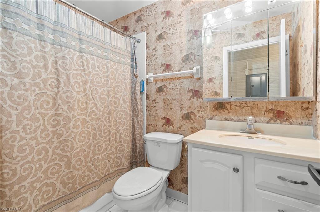 6184 Michelle Way, Unit 243 Fort Myers, FL 33919 - Photo 18 of 21 a bathroom with a toilet sink shower and mirror