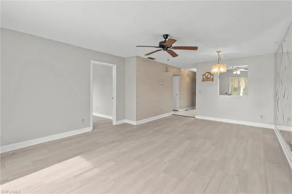 a view of a chandelier fan and entryway