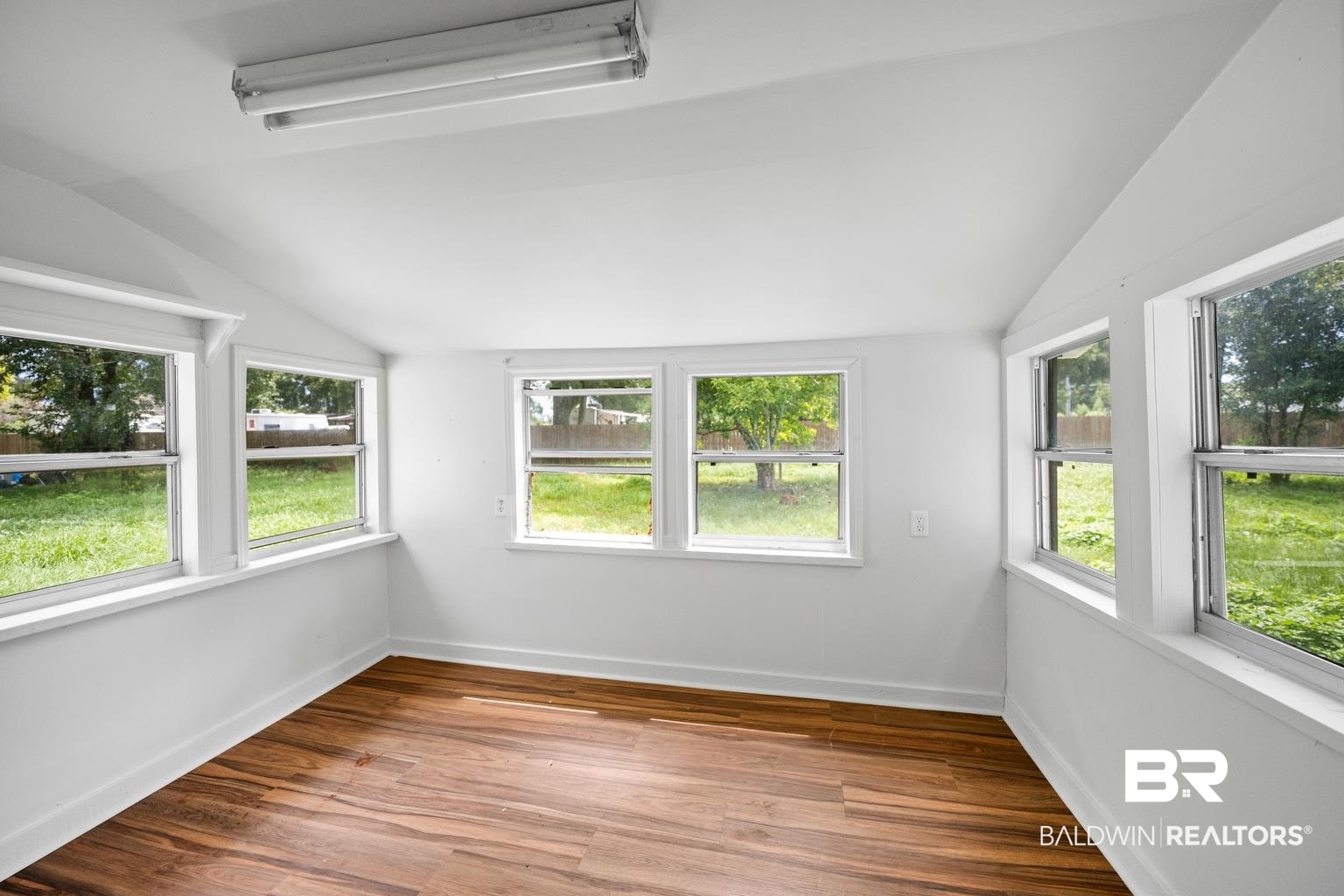 19575 Keller Road Foley, AL 36535 - Photo 9 of 17 Unfurnished sunroom featuring lofted ceiling and healthy amount of natural light