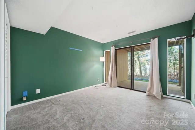 a view of an empty room with glass door