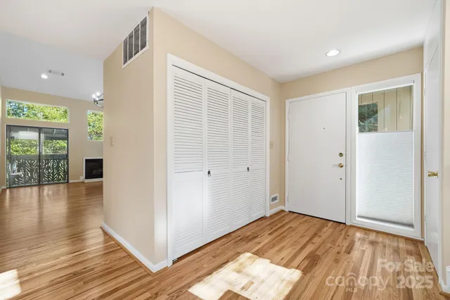 a view of a livingroom with wooden floor and windows