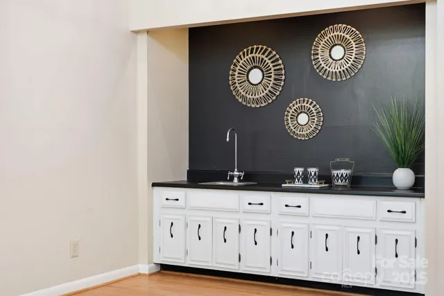 a view of bathroom with a sink and a mirror