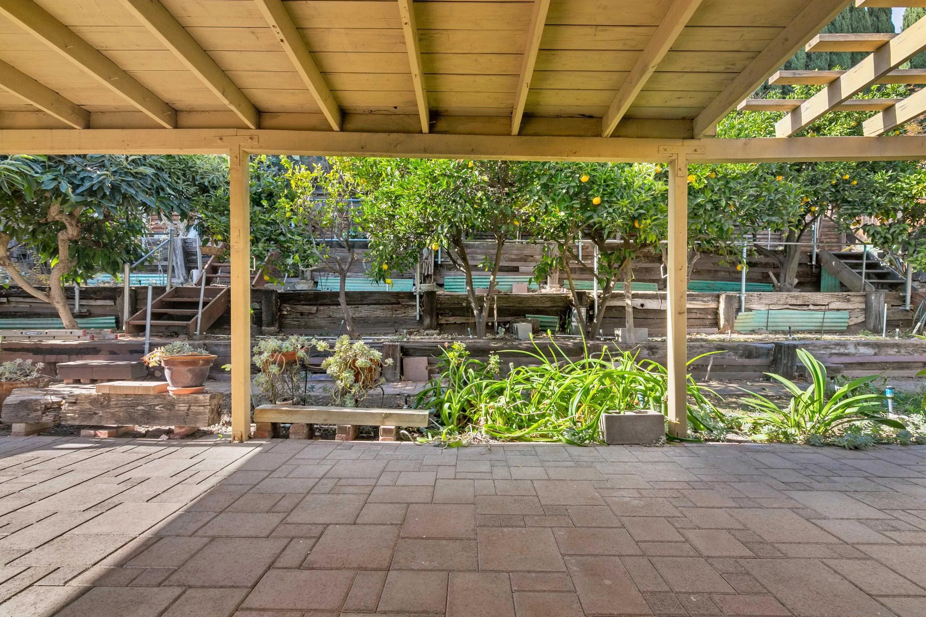 13840 Olive Grove Place Poway, CA 92064 - Photo 32 of 40 a view of a patio with table and chairs potted plants with the view of small yard