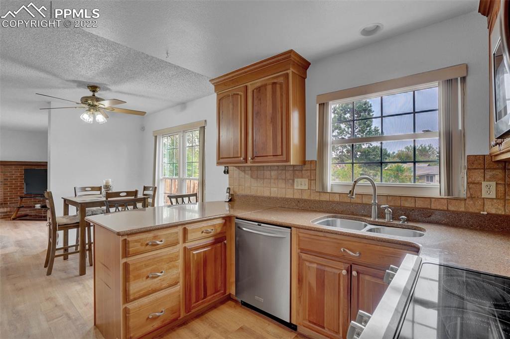 4930 Harvest Road Colorado Springs, CO 80917 - Photo 13 of 39 a kitchen with a sink stove and cabinets