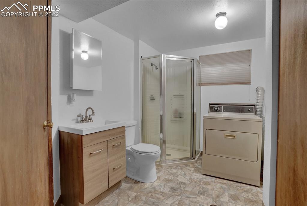 4930 Harvest Road Colorado Springs, CO 80917 - Photo 15 of 39 a bathroom with a toilet sink and mirror