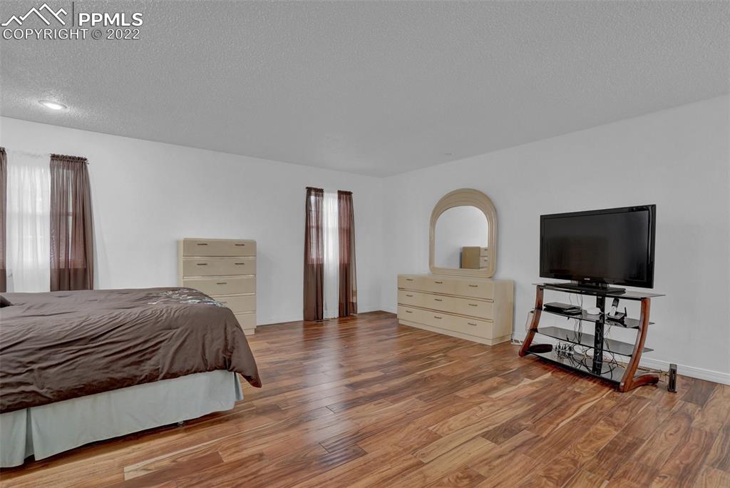 4930 Harvest Road Colorado Springs, CO 80917 - Photo 20 of 39 a bedroom with a bed and a flat screen tv