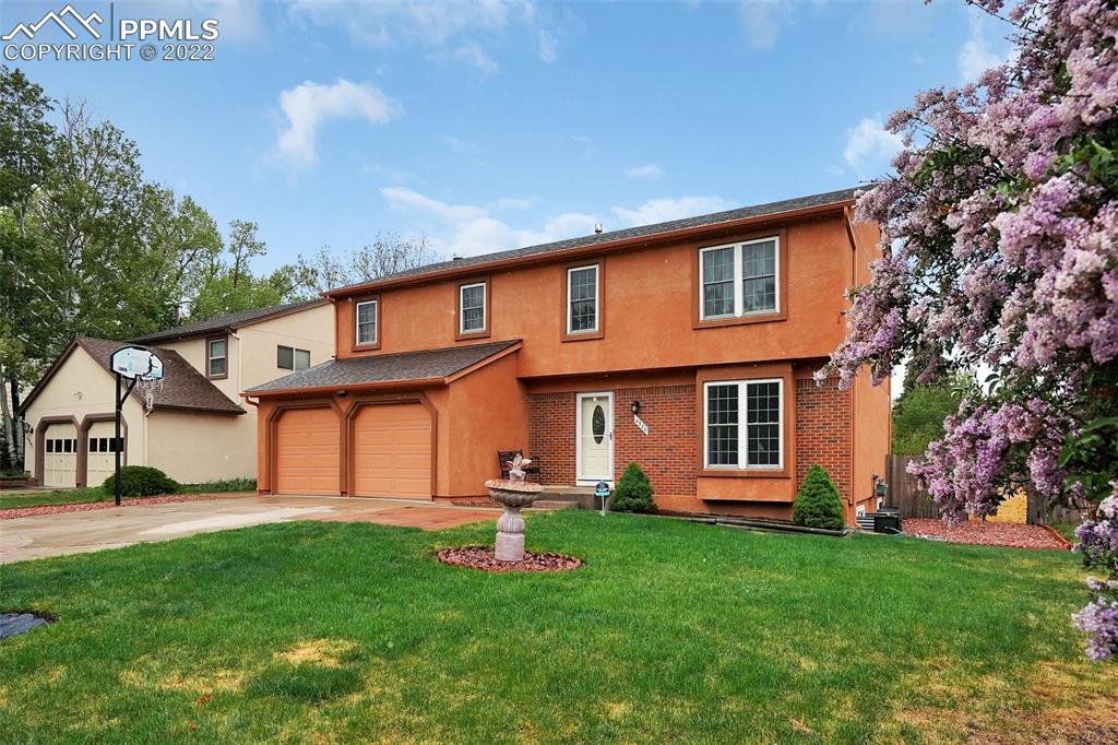 4930 Harvest Road Colorado Springs, CO 80917 - Photo 2 of 39 a front view of a house with a garden