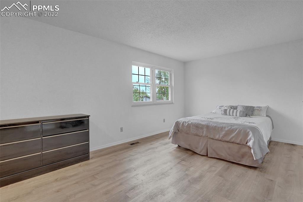 4930 Harvest Road Colorado Springs, CO 80917 - Photo 27 of 39 a bedroom with a bed and window