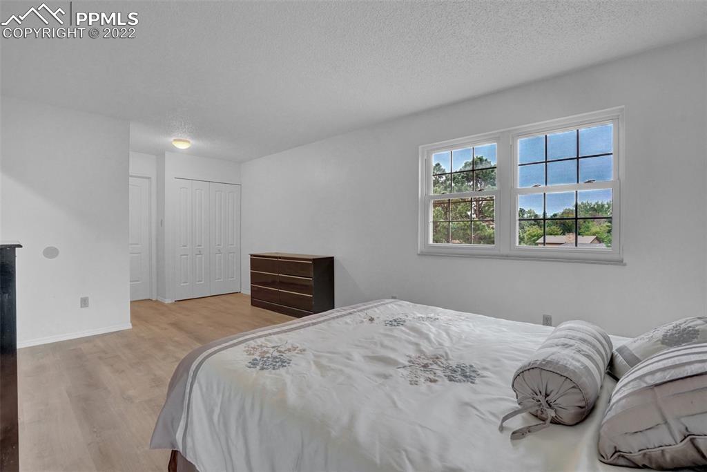 4930 Harvest Road Colorado Springs, CO 80917 - Photo 28 of 39 a bedroom with a large bed and a window