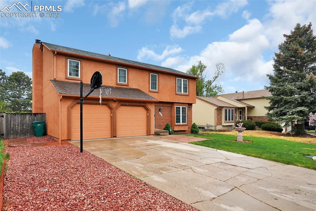 4930 Harvest Road Colorado Springs, CO 80917 - Photo 3 of 39 a front view of a house with a yard