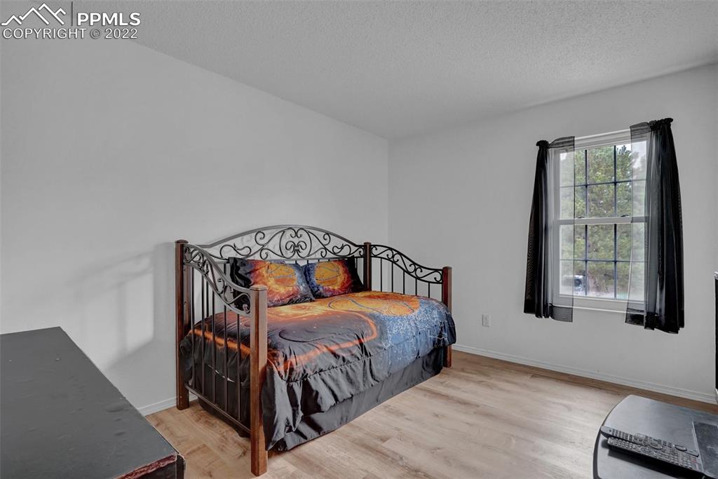 4930 Harvest Road Colorado Springs, CO 80917 - Photo 31 of 39 a bedroom with a bed and window